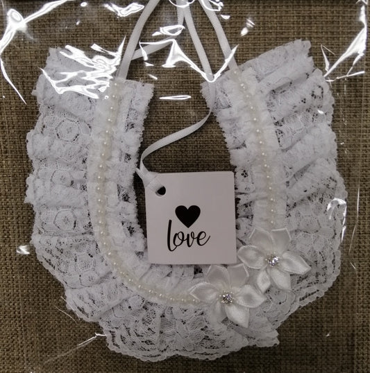 BBHS40W  White lace bridal horseshoe with pearls and satin flowers.