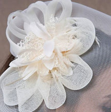 FAC1003CR Classic, cream fascinator with central flower and mesh.