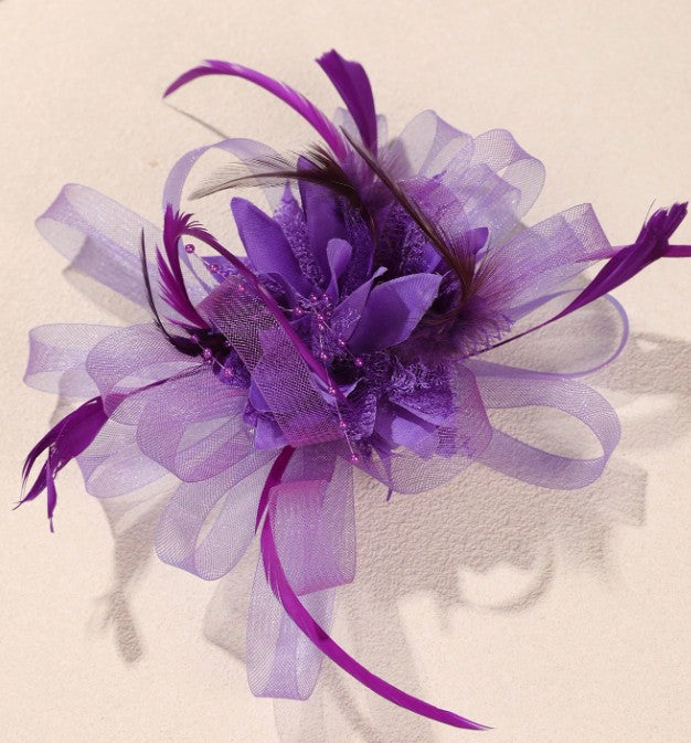 FAC10115P Classic, purple fascinator with central flower and feathers.