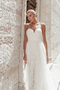 71430 A beautiful beaded fit and flare with attached overskirt.