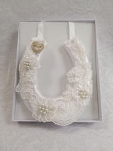 BBHS19 white satin bridal horseshoe with pearls and light ivory lace embellishments.