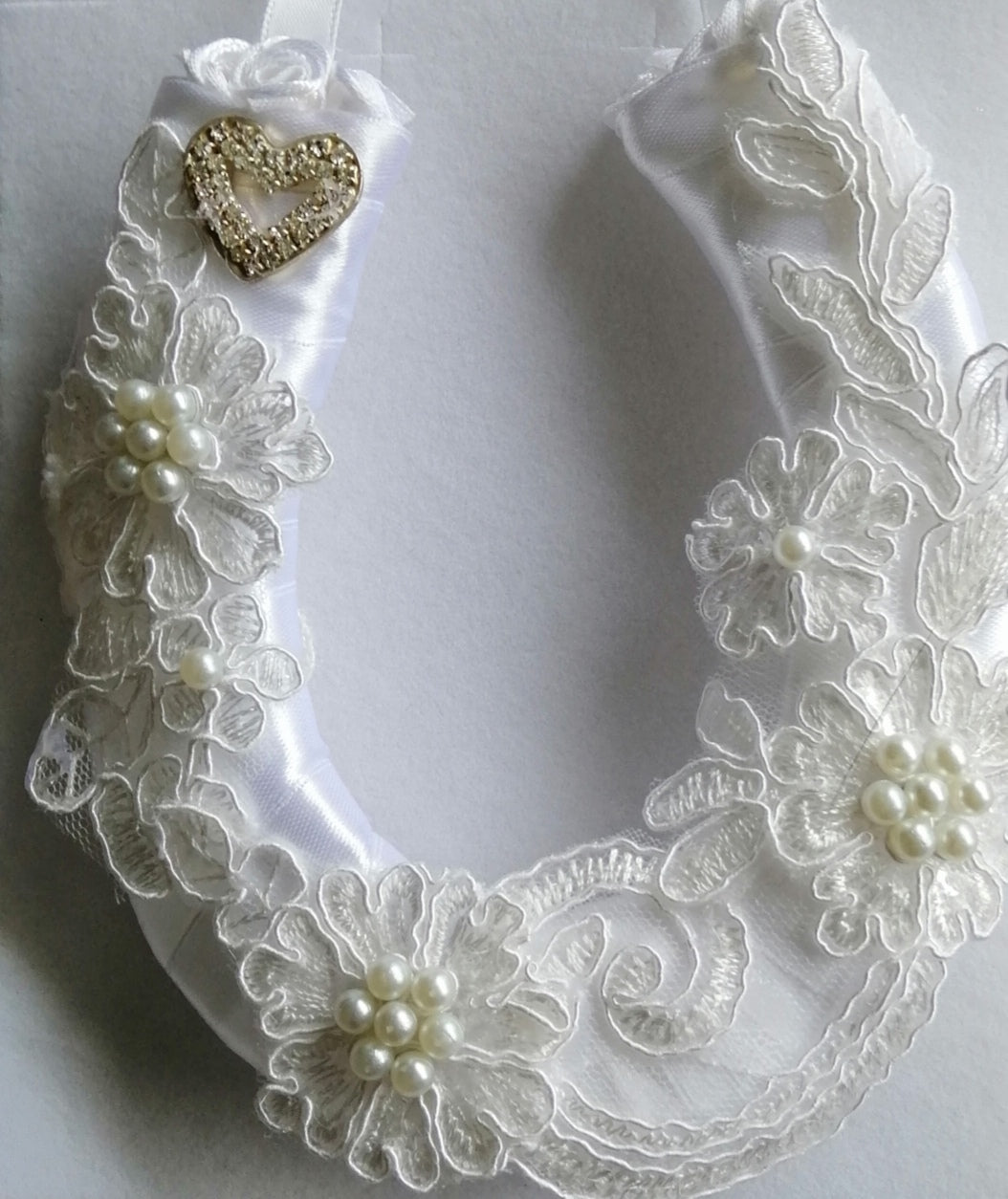 BBHS19 white satin bridal horseshoe with pearls and light ivory lace embellishments.